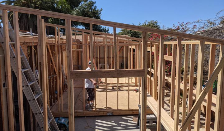 carpenter checking the home addition wood framing