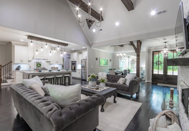 newly remodeled luxury kitchen and living room, classic couch and table in front of the fireplace