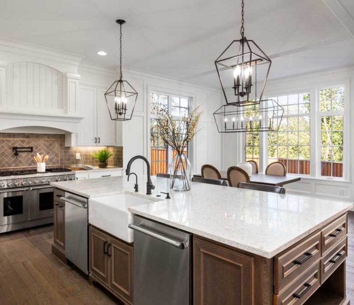Beautiful kitchen in new traditional style luxury home, with quartz counters, hardwood floors, and stainless steel appliances