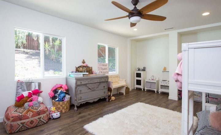 home addition, kids room with bunk beds, hardwood floors, toys, classic cabinet, window overlooking the yard